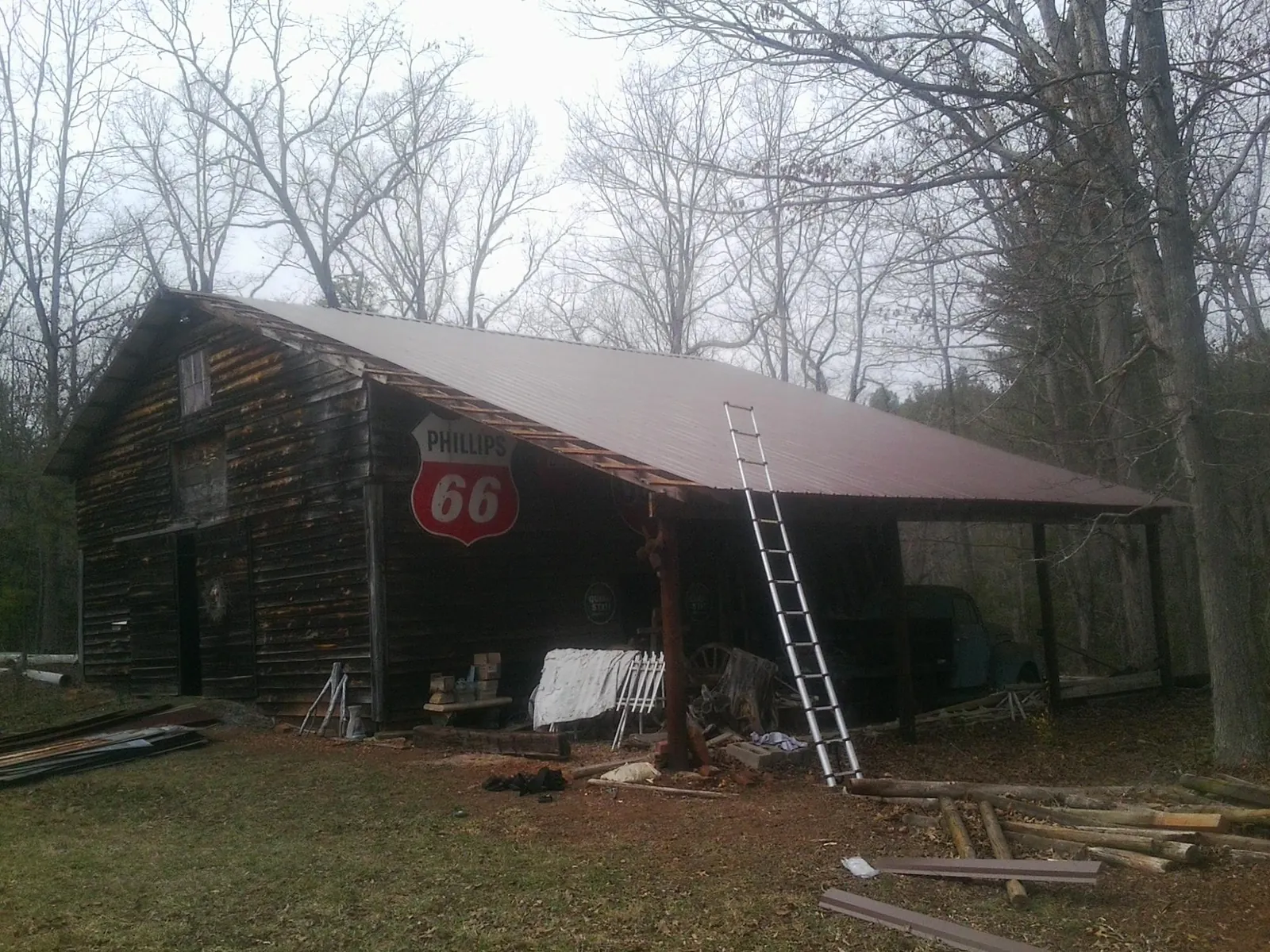 New metal roof on an open sided timber barn with a vintage sign in Saint Johns